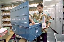 Treatment guidelines endorsed by the World Health Organization have worldwide impact. Here, Aldo Argola, a WHO librarian in Geneva, loads treatment guidelines and medical books into a trunk that will be sent to a health center that lacks up-to-date information. The WHO has sent these portable medical libraries to more than 1,400 health centers in 60 nations.