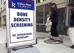 A sidewalk sign at Kelley-Ross Pharmacy in Seattle advertises bone-density screening. Such screening has proliferated in recent years, targeting younger, healthier people.