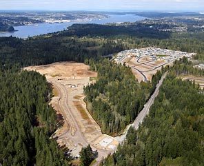 A pair of developments hems in a stand of trees containing Anderson Creek, which feeds directly into Sinclair Inlet near Port Orchard. Developments like this endanger Puget Sound by paving over ground that absorbs rainwater and by pouring pollutants into the runoff.