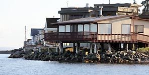 These homes rise above the water with a layer of rocks underneath. Bulkheads built today usually aren't as destructive as a generation ago.