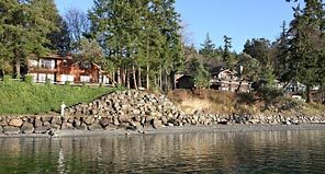  Piles of rock protect three homes on Bainbridge Island. Island government is trying to enforce rules to decrease bulkheads, but it isn't always effective.