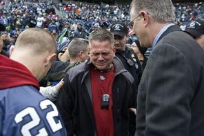 Before Sunday's football game, Seahawks CEO Tod Leiweke, right, meets with Lakewood police and their families, including Mike Renninger, center, brother of Sgt. Mark Renninger. A moment of silence was held for the four officers. 