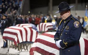 Honor Guard Jeremy Price of the Portland Police Bureau stands next to the casket of Lakewood Police Officer Greg Richards prior to the public memorial service for the fallen officers at the Tacoma Dome on Dec. 8. 