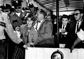 In town to film "It Happened at the World's Fair," Elvis Presley caused a sensation. Police kept the peace as best they could, but a few fans got close enough to snare an autograph from "the King." Filming for the first scenes were on the Monorail red train. Local extras were hired at $10 a day.