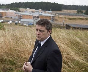 ON MCNEIL ISLAND: Superintendent Kelly Cunningham stands above the Special Commitment Center, where the state houses the worst sex offenders. Legal costs eat up about one-quarter of the center's $50 million budget each year. 