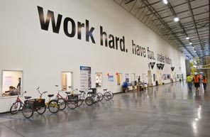 Amazon.com's motto is displayed in its state-of-the-art West Phoenix fulfillment center. Although this 2-year-old center has air conditioning, some older Amazon warehouses did not, and workers suffered from heat-related illnesses trying to keep up with the relentless drive to boost production.