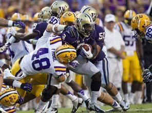 Washington's Kevin Smith is wrapped up by LSU defenders as the Huskies were held to just 26 yards rushing and 157 passing while the Tigers had 242 and 195. 