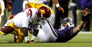 Washington quarterback Keith Price fumbles the ball after a hit by USC's Dion Bailey. It was the second fumble lost by Price in the fourth quarter of the Huskies' 24-14 loss. 