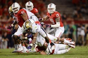 Washington running back Bishop Sankey is taken down in the third quarter. Sankey rushed for 89 yards and a touchdown. 