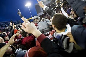 WSU players and fans celebrate on the field at Martin Stadium as the Cougars defeat the Huskies, 31-28, in overtime to win the 2012 Apple Cup.