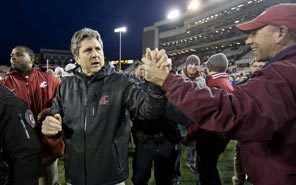 Fans cheer Washington State coach Mike Leach as he walks off the field following Friday's overtime win over Washington.