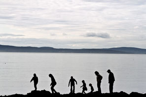 The Nichols family, from Arlington, walks along the rocks on West Beach at Deception Pass State Park. 