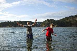 Kohner White, 11, and his brother Derrick, 9, visiting from Utah, splash in the cold, clear water at North Beach. 