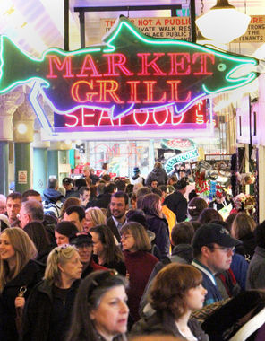 Visitors and locals alike throng the Pike Place Market to shop for flowers, pick up dinner or just watch flying fish. 