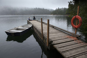 Morning mist   lingers at Mountain Lake in Moran State Park. Paddle on the peaceful lake or walk the four-mile trail around it. Or just relax on the dock, like Jennifer Imamura from Berkeley, Calif. (left) and Sylvia Yang of Anacortes. 