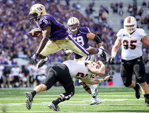 Washington wide receiver Kevin Smith flies over Idaho State's Tanner Davis for a 9-yard gain, much like the Huskies flew past the Bengals in gaining 680 yards.