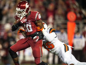 WSU receiver Dom Williams (80) gets tackled from behind by OSU’s  Rashaad Reynolds (16). The Cougars passed for 270 yards.
