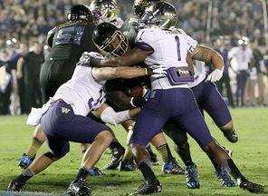 Myles Jack,  UCLA’s two-way freshman out of Bellevue High, bulls his way through the Washington defense in the second quarter for the third of his four touchdowns.
