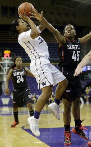 Washington guard Jazmine Davis shoots against Seattle University's Wilma Afunugo in the Huskies’  first victory of the season on Tuesday at Alaska Airline Arena. Davis, a junior,  had 18 points, eight assists and six rebounds.