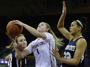  UW guard Mercedes Wetmore, center, drives for a layup against Montana State’s Kayla DeWit, left, and Alexa Dawkins  during the second half.