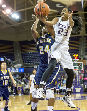 Washington’s Aminah Williams hops into the lane looking for a shot, but is fouled by UC Irvine’s Camille Buckley during first-half action of the Huskies’ victory.<br/>