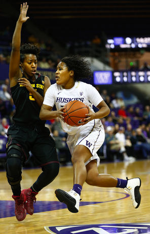 Jazmine Davis drives against ASU guard Deja Mann in the first half of the Huskies’ 78-60 loss to the Sun Devils at Alaska Airlines Arena. Davis had 23 points. <br/>