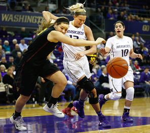 ASU’s Sophie Brunner, left, fights UW’s Katie Collier, middle, for a loose ball during the Huskies’ 78-60 loss at home. Collier, coming off an injury, played just eight minutes.<br/>