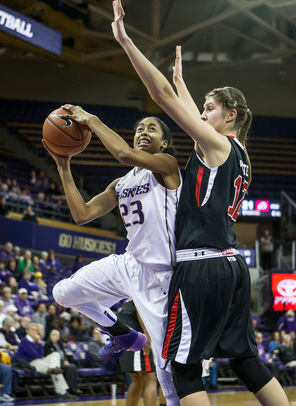  Washington’s Aminah Williams eyes the bucket as she works her way around Utah's Emily Potter. Williams finished with three points and 15 rebounds for the Huskies.