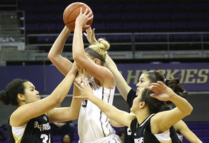 UW's Katie Collier gets a faceful in the midst of  Colorado’s  Zoe Beard-Fails, left, Lauren Huggins, top right, and Haley Smith,  bottom right. The Huskies, with a 45-33 rebounding edge,  beat the Buffaloes, 81-71.
