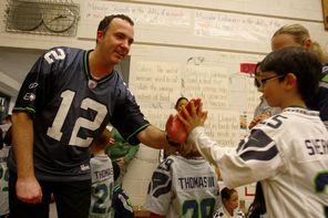 Kevin Zelko, a teacher at Kimball Elementary, greets students after an assembly Friday celebrating the Seahawks jerseys he helped purchase for every student. “I’m so excited to bring Seahawks spirit to all of Seattle and to all of the kids at my school,” he said. 