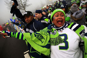 Marcia Shiri-Wasto cheers with other fans in SeaTac as the Seahawks buses near the airport Sunday morning. “We’re going to win the game for sure,” she said.