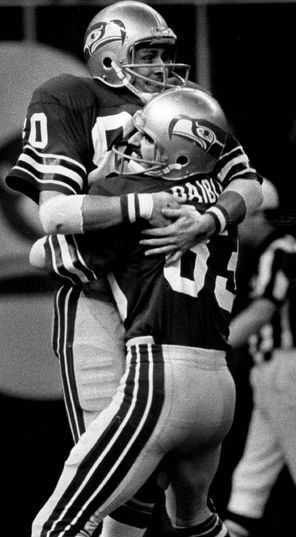 Seahawks receiver Steve Largent, left, is lifted off the ground by Steve Raible after Largent caught a 43-yard touchdown pass to beat Denver for the first time.