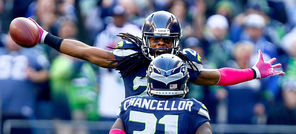 Richard Sherman celebrates with Kam Chancellor after an Oct. 13 interception. “When you know him, it’s funny,” Chancellor said of Sherman’s controversial postgame interview. 