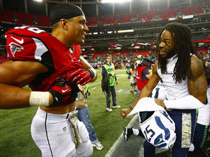 Richard Sherman exchanges jerseys with Atlanta Falcons tight end Tony Gonzalez, left, in a gesture of friendship after their game Nov. 10. 
