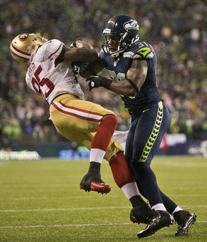  Seahawks safety Kam Chancellor lays out San Francisco 49ers tight end Vernon Davis during a game last season, earning an unnecessary roughness penalty.