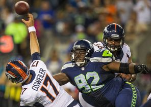  Seahawk Brandon Mebane, right, swoops in on backup Denver Broncos quarterback Brock Osweiler to finish off a sack for a 7-yard loss in their exhibition game. Mebane joined the team in 2007.