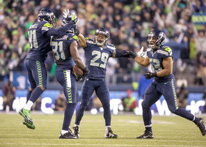 The Seahawks defense celebrated a lot this season, including this interception by  Kam Chancellor, second from left.