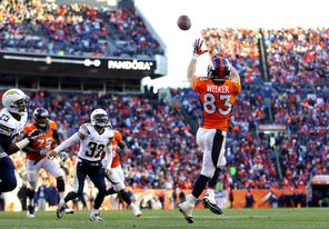 Wes Welker hauls in a touchdown pass against San Diego in a playoff win. The former New England star is just one of several players Peyton Manning likes to throw to.