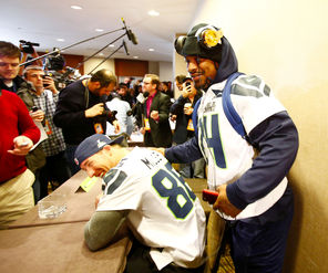  Seahawks running back Marshawn Lynch, right, scoots by teammate Zach Miller to leave a media availability session early.