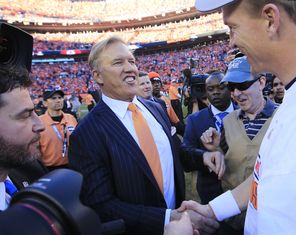DENVER, CO - JANUARY 19: John Elway, executive vice president of football operations for the Denver Broncos, celebrates with Peyton Manning #18 after they defeated the New England Patriots 26 to 16 during the AFC Championship game at Sports Authority Field at Mile High on January 19, 2014 in Denver, Colorado. (Photo by Jamie Squire/Getty Images) -- 463736997