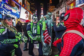 Seahawks fans, including Bruce McMillan (second from left), are in game-day form while walking the streets of New York City on Friday night.