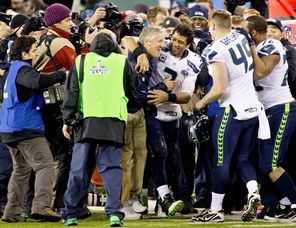 Seahawks  coach Pete Carroll gets an embrace from quarterback Russell Wilson (3) after the final seconds elapsed in Seattle’s 43-8 Super Bowl win over the Broncos.