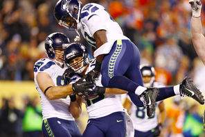  Jermaine Kearse (15) celebrates with  Zach Miller, left,  and   Derrick Coleman, top, after his TD catch.<br/>