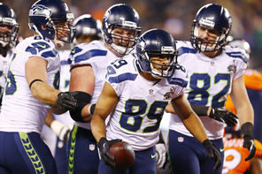 Seahawks players gather around wide receiver Doug Baldwin (89) after Baldwin scores  on a 10-yard touchdown on a  pass from Russell Wilson during the fourth quarter.<br/>