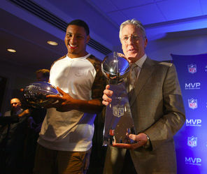 The Seahawks’ Super Bowl MVP Malcolm Smith, left, and winning coach Pete Carroll pose with their NFL finery Monday. Carroll is holding the  Lombardi Trophy, which goes to the team that wins the  Super Bowl.