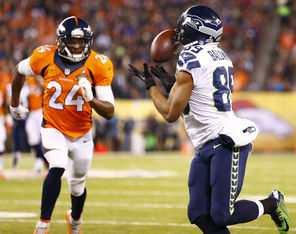  Doug Baldwin brings in a 37-yard pass from Russell Wilson before being brought down by Denver's Champ Bailey during the first quarter. Baldwin   led the Seahawks with five catches for 66 yards and a touchdown.