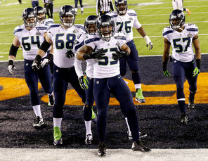 Super Bowl MVP Malcolm Smith (53), celebrating his second-quarter TD, is one of several young Seahawks under contract at a bargain price.