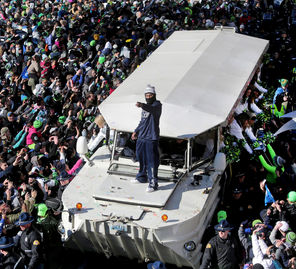 Skittles tossed by both Marshawn Lynch and spectators litter the bow of a Duck boat carrying Lynch and members of the Sea Gals during Wednesday’s parade through Seattle. 