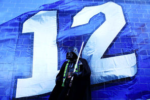 A fan dressed as Darth Vader poses next to CenturyLink Field during Wednesday’s celebration. 