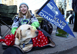  Kaitlyn Steffy, 10, of Woodinville, and her dog, Tina, staked out their spot early to view the Seattle Seahawks Super Bowl Parade and Rally on Fourth Avenue in downtown Seattle.   